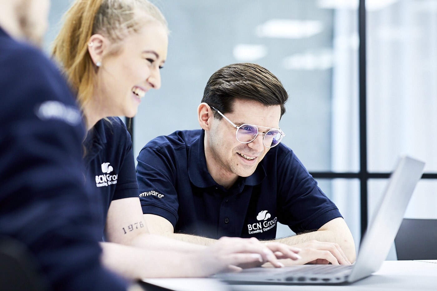 BCN team members collaborating at a laptop