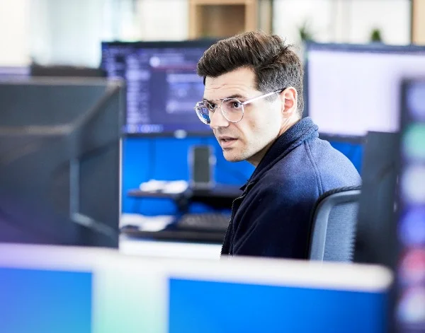 BCN team member reviewing data on screen in the office